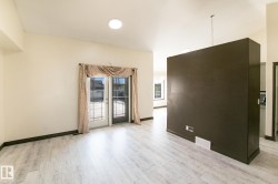 Light wood-finish flooring complements the neutral wall color - 