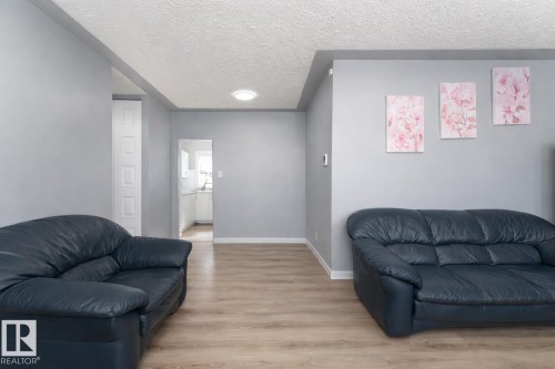 Living area featuring light-colored flooring, light grey walls, and recessed lighting - 16131 109 Avenue, Edmonton, AB - Indoor Photo Showing Living Room