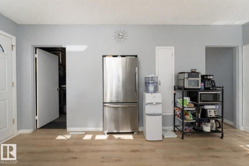 This interior space features light-colored plank flooring and light grey walls - 16131 109 Avenue, Edmonton, AB - Indoor