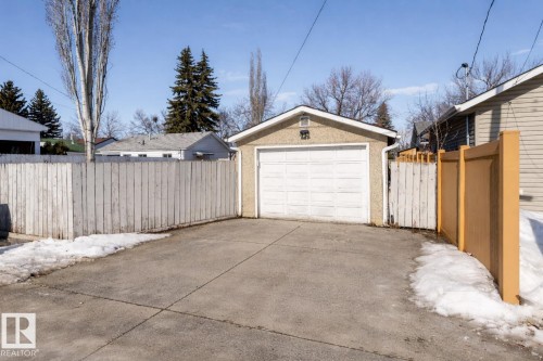 Detached garage with a driveway and surrounding fencing - 16131 109 Avenue, Edmonton, AB - Outdoor