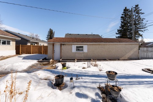 The property features a detached garage with a side entry door and a window - 16131 109 Avenue, Edmonton, AB - Outdoor
