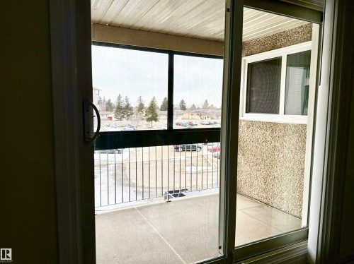 This property features a balcony with a metal railing and an exterior textured wall - 307 1620 48 Street, Edmonton, AB -  Photo Showing Other Room
