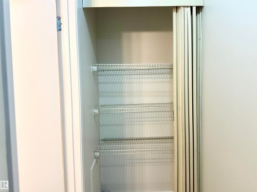 This closet features wire shelving and a bi-fold door - 307 1620 48 Street, Edmonton, AB - Indoor With Storage
