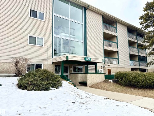 The property features a multi-story building with a light-colored exterior and green trim - 307 1620 48 Street, Edmonton, AB - Outdoor With Balcony