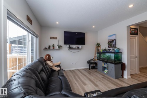 Living space featuring light-toned flooring, a sliding glass door, and recessed lighting - 159 Larch Crescent, Leduc, AB - Indoor