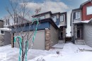 This property features a two-story exterior with a garage door and a front entrance - 159 Larch Crescent, Leduc, AB  - Outdoor With Facade 