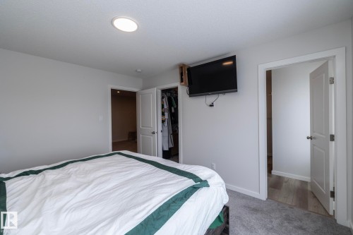 This room features light gray walls, a light gray carpet, and recessed lighting - 159 Larch Crescent, Leduc, AB - Indoor Photo Showing Bedroom