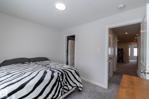 This room features light-colored walls, recessed ceiling lighting, and soft grey carpet - 159 Larch Crescent, Leduc, AB - Indoor Photo Showing Bedroom