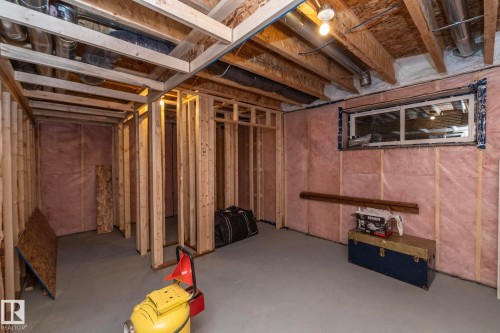 The property includes a partially finished basement with exposed wooden framing and insulation on the walls - 159 Larch Crescent, Leduc, AB - Indoor Photo Showing Basement