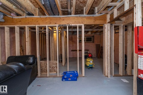 The property features a partially finished basement with exposed wooden framing, providing an opportunity for customization - 159 Larch Crescent, Leduc, AB - Indoor Photo Showing Basement