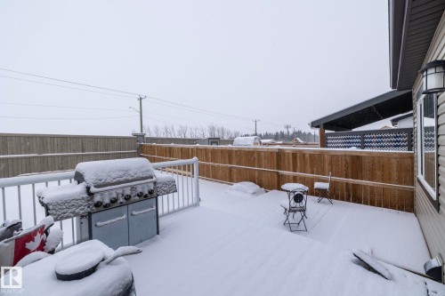 Rear deck area featuring a white railing and a privacy fence - 159 Larch Crescent, Leduc, AB - Outdoor With Exterior