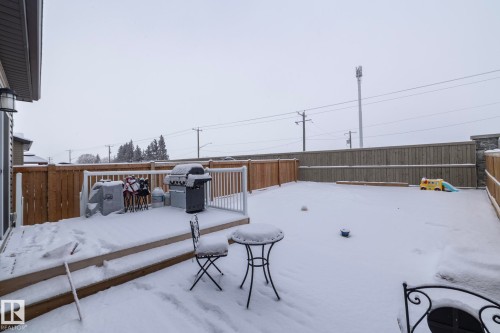 The property features a fenced backyard with a wooden deck, providing an outdoor living space - 159 Larch Crescent, Leduc, AB - Outdoor With Exterior
