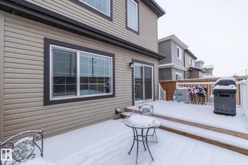 The property features a private deck with railings and a sliding glass door entry - 159 Larch Crescent, Leduc, AB - Outdoor With Deck Patio Veranda With Exterior