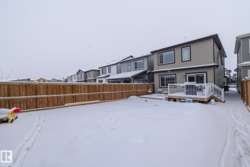 The property features a fenced yard with a deck - 159 Larch Crescent, Leduc, AB - Outdoor With Deck Patio Veranda