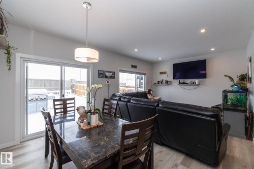 This open concept space features light-colored flooring and recessed lighting - 159 Larch Crescent, Leduc, AB - Indoor Photo Showing Dining Room