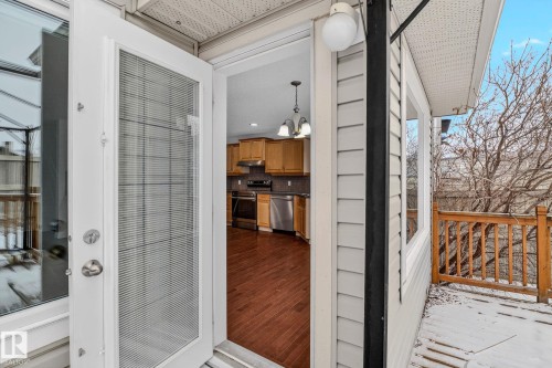 The property features a white exterior door with glass panels opening to an outdoor deck with wooden railings - 978 Rutherford Road Sw, Edmonton, AB -  With Exterior