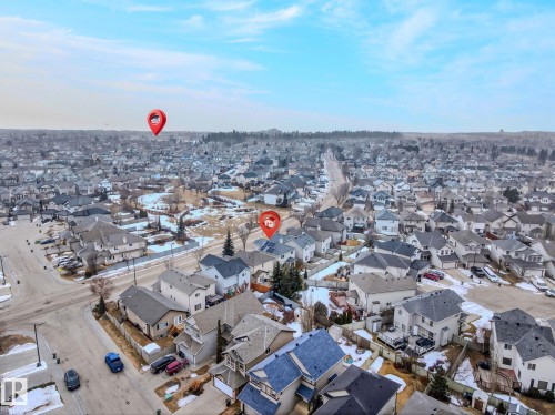 Aerial view showcasing the residential area with detached houses and a clear sky - 978 Rutherford Road Sw, Edmonton, AB - Outdoor With View
