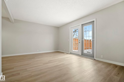 This room features light wood-style flooring and light-colored walls, creating a bright and open atmosphere - 3311 139 Avenue, Edmonton, AB - Indoor Photo Showing Other Room