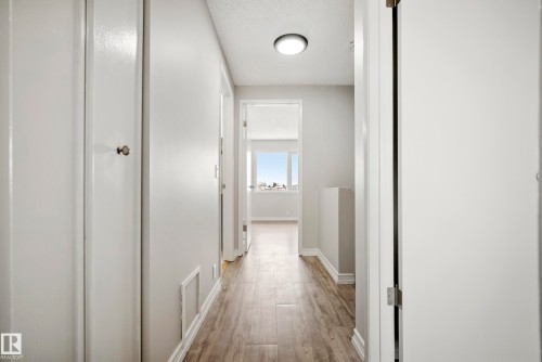 The property features light-colored plank flooring, white walls, and bright overhead lighting - 3311 139 Avenue, Edmonton, AB - Indoor Photo Showing Other Room