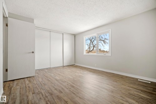 This room features light-toned wood-style flooring and light-colored walls - 3311 139 Avenue, Edmonton, AB - Indoor Photo Showing Other Room