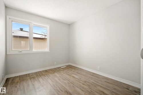 This room features light-colored walls and wood-style flooring - 3311 139 Avenue, Edmonton, AB - Indoor Photo Showing Other Room