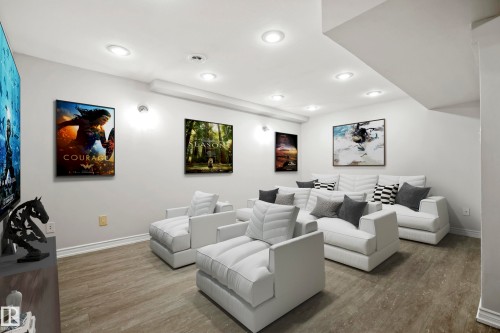 The entertainment area features recessed lighting, light-colored walls, and wood-look flooring - 3311 139 Avenue, Edmonton, AB - Indoor