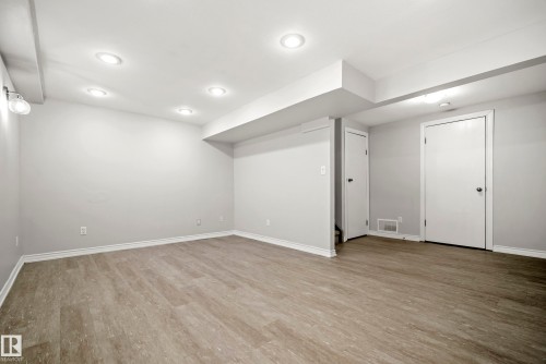 Spacious room featuring light-colored flooring, recessed lighting, and bright white trim - 3311 139 Avenue, Edmonton, AB - Indoor