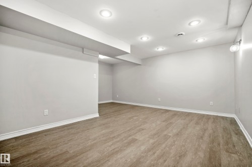This property features light gray walls, recessed ceiling lighting, and a wall-mounted light fixture - 3311 139 Avenue, Edmonton, AB - Indoor