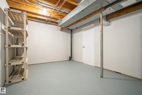 The property features a utility area with painted walls and a light grey floor - 3311 139 Avenue, Edmonton, AB - Indoor Photo Showing Basement