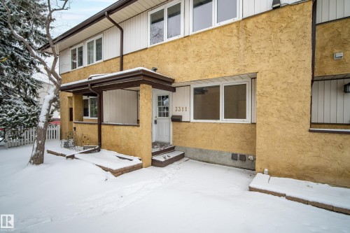 The property features a stucco exterior, white trim windows, and a covered entry - 3311 139 Avenue, Edmonton, AB - Outdoor