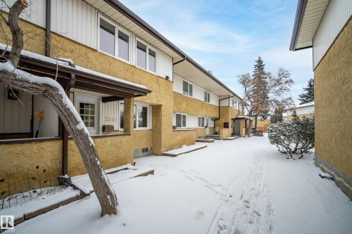 The property features an exterior with stucco siding and white trim, offering a clean and uniform appearance - 3311 139 Avenue, Edmonton, AB - Outdoor With Exterior