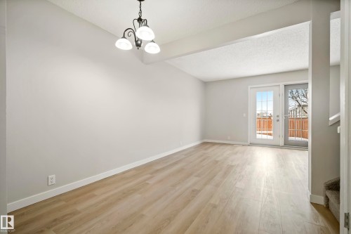 The living space features light-toned flooring and neutral wall colors - 3311 139 Avenue, Edmonton, AB - Indoor Photo Showing Other Room
