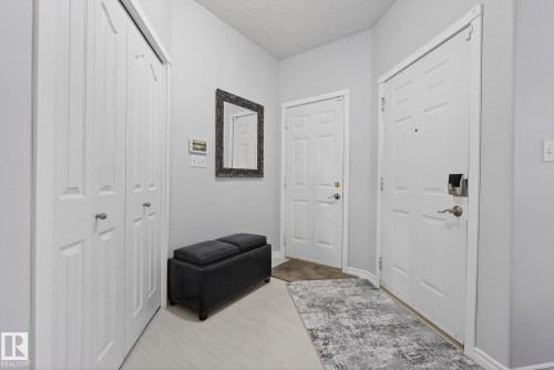 Entryway with light-toned flooring, white walls, and a convenient closet with bifold doors - 17204 113 Street, Edmonton, AB - Indoor Photo Showing Other Room