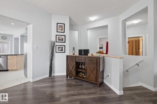 The property features light gray walls and dark wood-style flooring throughout - 17204 113 Street, Edmonton, AB - Indoor Photo Showing Other Room