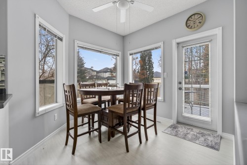 This dining area features light-colored flooring, white trim, and a ceiling fan - 17204 113 Street, Edmonton, AB - Indoor Photo Showing Dining Room