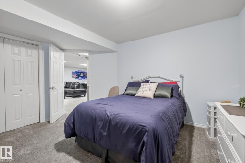 This room features light blue walls, gray carpeting, and a white bi-fold closet door - 17204 113 Street, Edmonton, AB - Indoor Photo Showing Bedroom