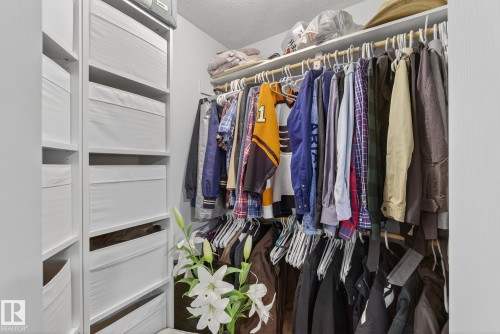 Walk-in closet featuring built-in shelving and ample hanging space - 17204 113 Street, Edmonton, AB - Indoor With Storage
