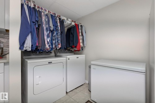 Laundry area featuring tile flooring, white walls, and a white ceiling - 17204 113 Street, Edmonton, AB - Indoor