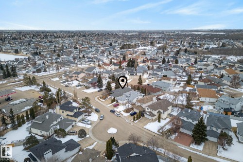 Aerial view of the property and its surrounding residential area, featuring a grid of streets and various single-story homes with snow-dusted roofs and yards - 17204 113 Street, Edmonton, AB - Outdoor With View