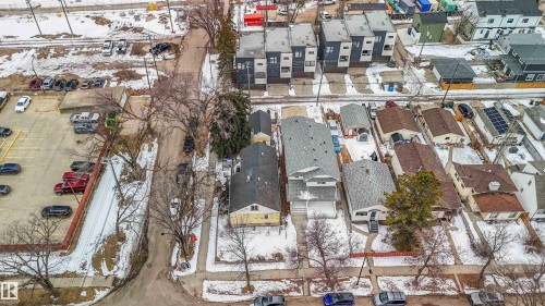 This aerial view showcases the property's advantageous position within the neighborhood, featuring access to a paved road and proximity to various other properties - 10186 143 Street, Edmonton, AB - Outdoor With View