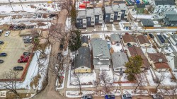 This aerial view showcases the property's advantageous position within the neighborhood, featuring access to a paved road and proximity to various other properties - 