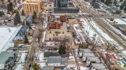 This aerial view showcases the property's advantageous location within a developed area, surrounded by various residential and commercial structures - 