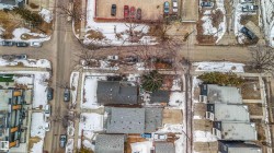 Aerial view showcasing the property's surrounding neighborhood, including residential streets and nearby residences - 
