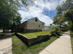 Property exterior featuring wood siding, a visible foundation, and a rear deck - 