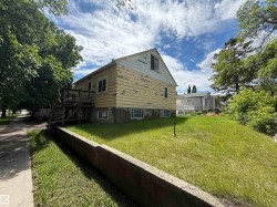 Two-story residence featuring wood siding and a concrete foundation - 