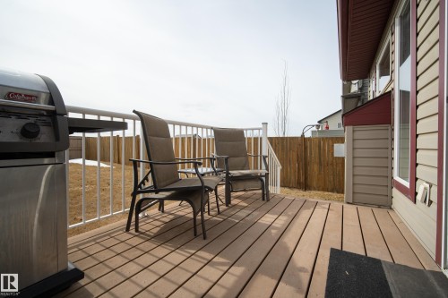The property features a spacious rear deck with railing and a view of the fenced yard - 9051 Scott Crescent, Edmonton, AB - Outdoor With Deck Patio Veranda With Exterior
