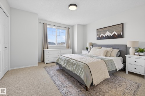 The property features a bright room with carpeted flooring, a window providing natural light, and a ceiling light fixture - 9051 Scott Crescent, Edmonton, AB - Indoor Photo Showing Bedroom
