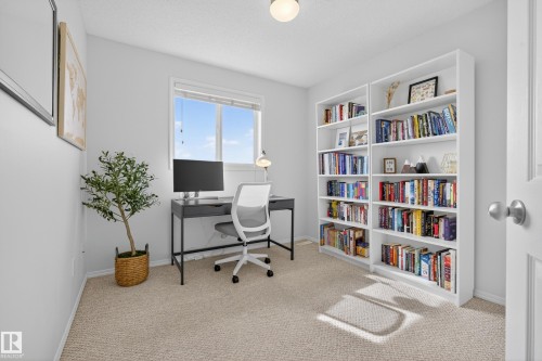Bright room featuring a window, carpeted flooring, and built-in shelving - 9051 Scott Crescent, Edmonton, AB - Indoor Photo Showing Office