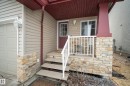 The property features a welcoming front entrance with stone veneer accents and a covered porch - 9051 Scott Crescent, Edmonton, AB  - Outdoor With Exterior 