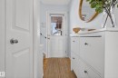 Entryway featuring a white door with a window, wood flooring, and a light blue wall - 9051 Scott Crescent, Edmonton, AB  - Indoor Photo Showing Other Room 